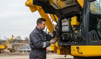 Technician assessing an excavator